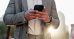 Phone, hands and closeup of businessman in the city scroll on social media, mobile app or the internet. Technology, professional and male corporate lawyer browsing on cellphone in an urban town road.