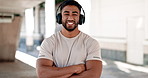 Face, fitness and music with a man arms crossed in the city for cardio training or marathon preparation. Portrait, smile and music with a happy young athlete in an urban town for a summer workout