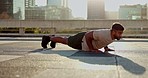 Fitness, training and man on the floor for exercise, wellness and morning cardio routine outdoor. Rooftop, workout and male athlete on ground for body, lifting or resilience, energy or planking power