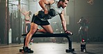 Man, dumbbell and weightlifting in fitness, workout or arm exercise on bench at indoor gym. Serious male person, bodybuilder or athlete lifting weight in sports training, health and wellness at club