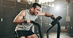 Asian man, fitness and cycling at gym in cardio workout, exercise or intense training on machine. Active male person on bicycle equipment in sweat or running for muscle, endurance or stamina at club