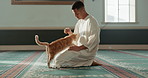 Cat, islamic and man with pet in a mosque for praying, peace and spiritual care in holy religion for Allah. Respect, gratitude and Muslim person with kindness for animal or kitten after worship