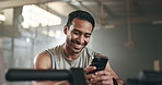 Happy asian man, phone and fitness on break in social media, communication or networking at gym. Active male person smile for online texting or chatting on mobile smartphone app at indoor health club