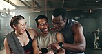 Friends, phone and reading with laughing, gym or pointing with meme, funny joke or smile with web blog. Men, woman and fitness team with smartphone, comic video or memory for training in workout room