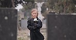 Flower, death or kid in cemetery for funeral. spiritual service or grave visit for repsect in Christian religion. Mourning, goodbye or sad girl child outside in graveyard for grief, loss or farewell