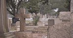 Funeral, cemetery and cross on tombstone for death ceremony, religion or memorial service. Catholic symbol, background or Christian sign on gravestone for mourning, burial or loss in public graveyard