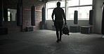 Gym, walking and fitness of a man with a bag to start exercise, sports training or workout for wellness. Back of an athlete person arrival at health club for healthy body, strong muscle or commitment