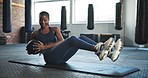 Fitness, gym and black woman on floor with ball for core training, exercise and cardio workout on yoga mat. Sports, Russian twist and person for equipment for wellness, performance or muscle strength