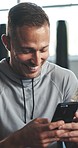 Funny, exercise and man with a cellphone, typing and relax with workout, connection and meme. Person, health or guy with smartphone, mobile app or laugh with social media, humor or break with fitness