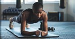 Strong, plank and a black woman at the gym for fitness, posture and training with endurance. Muscle, sports and an African athlete at a club for pilates, workout or balance on the floor for health
