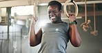 Sports, gymnastics and black man doing pull up exercise for arm muscle training or workout in gym. Fitness, bodybuilding and African male athlete doing an intense strength challenge in health center.