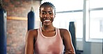 Fitness, face and a black woman with arms crossed at the gym for health, sports or workout. Happy, portrait and an African person or athlete with confidence in exercise, training or cardio at a club