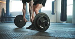 Barbell, man and gym exercise for deadlift, training challenge and workout in fitness club. Closeup of strong bodybuilder lifting heavy weights on ground for performance, action and muscle power 