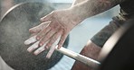 Person, barbell and powder hands for gym exercise, challenge and workout for muscle, fitness and training. Closeup, strong bodybuilder and chalk on palm for weightlifting, grip and power performance
