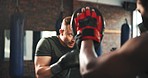 Sports coach, fitness man and boxer punch training, learning fighting skill or battle exercise, practice or muay thai workout. Gym club, partner teamwork or personal trainer coaching kickboxing power