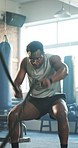 Gym, rope and black man with exercise, training and fitness with endurance, muscle and wellness. African person, athlete and guy with workout, training and bodybuilder with health, energy and power