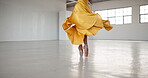 Dance, feet and a ballet woman for performance in a creative art studio with energy and passion. Legs, spin and shoes of ballerina dancer for theater and freedom with balance, textile and space