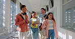 University, group and students walking on campus for education together in a corridor as friends with a scholarship. Learning, diversity and people in conversation happy in college or school hallway