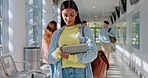 Education, tablet and a student woman walking on campus for university or college class to study. School, scholarship and technology with an academic person learning while in a corridor or hallway