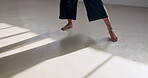 Dancing, performance and feet in a creative art studio with energy and passion. Legs of contemporary dancer practice for theater, sports and freedom with balance, exercise and talent with space