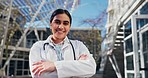 Face, doctor and woman with arms crossed, smile and outdoor with pride for career, sunshine and lab coat. Portrait, person and medical professional with confidence, healthcare and happiness outside