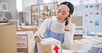 Ecommerce, woman with phone call and boxes, writing and checking sales and work at Japanese fashion startup. Online shopping, package and small business owner with smartphone, orders and networking.