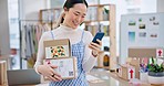 Package, startup and Asian woman with phone for business at a fashion retail boutique. Networking, technology and young female entrepreneur with cardboard boxes and cellphone for delivery information