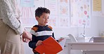 Boy, reading and book with presentation, teacher and oral assessment in classroom, development or language. Male kid, story and speech with test, literature and education in class, school or academy