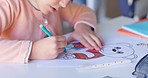Girl child, drawing and color in classroom, learning and development with art, animal sketch or paper at desk. Female kid, writing and notebook for bear, education or pen for study, academy or school