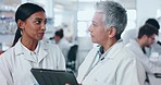 Science, tablet and mentor conversation with senior woman in a laboratory for pharmaceutical research. Online medical data, discussion and scientist talk with clinic study analysis and communication