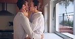 Relax, morning or couple kiss in kitchen for romance, care or bonding together in an intimate connection. Man, woman and romantic people hug in celebration of marriage anniversary at home with love