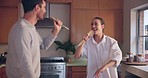 Singing, smile or happy couple in home kitchen bonding together for fun freedom on holiday vacation. Cooking meal, woman or man dancing in celebration of marriage anniversary in the morning to relax