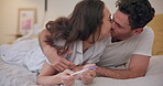 Love, bed and pregnancy test with a couple kissing in celebration of good news together in their home. Family, pregnant or maternity with a man and woman in the bedroom happy at a positive result