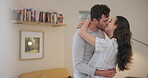 Love, couple kiss and dance in home, happy and bonding together on romantic date. Intimate, man and woman moving, care or smile for connection in healthy relationship, commitment or marriage at house