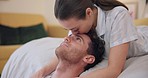 Love, couple and kiss forehead in bedroom, happy and bonding together in romance. Intimate touch, man and woman on bed, care and connection in healthy relationship, commitment and marriage at home