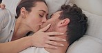 Love, bedroom and face of couple kiss, connect and bonding in morning wellness, rest and intimate relationship. Home, marriage partner trust and relax man, woman or romantic people together on bed