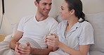 Couple, morning and coffee in bed talking about comfort, relax and smile or love. Happy man and woman together in a home bedroom for healthy marriage, communication and tea cup for wellness and chat