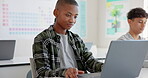Teenager child, laptop and education at school with research, coding or computer science. Black kid in classroom with technology for learning, problem solving and system or software study at academy