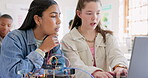 Robotics, children and education with laptop at school learning coding, robot or programming. Girl students in classroom for technology, electronics or science for development, innovation or teamwork