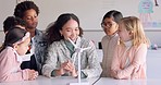 Education, windmill and woman with children in class learning clean energy or eco friendly information. Science, sustainability and teacher teaching natural power or electricity to students at school