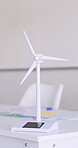 Wind turbine, renewable energy and model on a classroom desk for education, innovation or sustainability. Learning, design and environmental development with a small windmill for industrial ecology