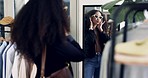 Woman, store and fitting sunglasses in mirror, choice and thinking with style in shopping mall. Girl, fashion and customer experience for lens, kiss or decision for design, frame or product quality