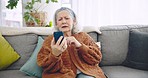 Home, video call and old woman on a couch, smartphone and connection with communication, mobile app and talking. Senior person, pensioner or elderly lady on a sofa, cellphone or contact with greeting