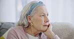 Face, depression and thinking with a senior woman in her retirement home feeling sad or lonely. Mental health, psychology or alzheimers  with an elderly person closeup in the living room alone