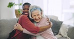 Senior woman, caregiver and hug with love on sofa or happiness on face in nursing home, house or living room with support. Happy, embrace and portrait of elderly lady with care and kindness of nurse