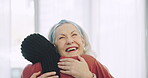 Surprise, senior woman and caregiver hug with love, support and happiness on face in nursing home, house or living room. Happy, embrace and portrait of elderly lady with care, kindness and empathy