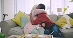 Hug, breakfast and woman with a senior woman on a sofa on a weekend morning at a modern home. Happy, coffee and African girl embracing elderly female person enjoying food together in the living room.