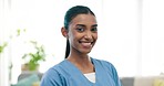 Smile, happy and face of woman nurse in medical office in a hospital for consultation. Excited, professional and portrait of young Indian female healthcare worker with confidence in a nursing clinic.