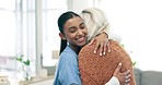 Hug, support and nurse with senior woman for healthcare consultation in a retirement home. Happy, smile and Indian female medical worker embracing an elderly patient with empathy in a nursing clinic.