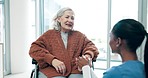 Smile, conversation and nurse with senior woman in a wheelchair for medical consultation in nursing home. Happy, healthcare and elderly patient holding hands and talking to female caregiver in clinic